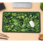 Black Kittens among Green Houseplants desk mat — product mockup 1